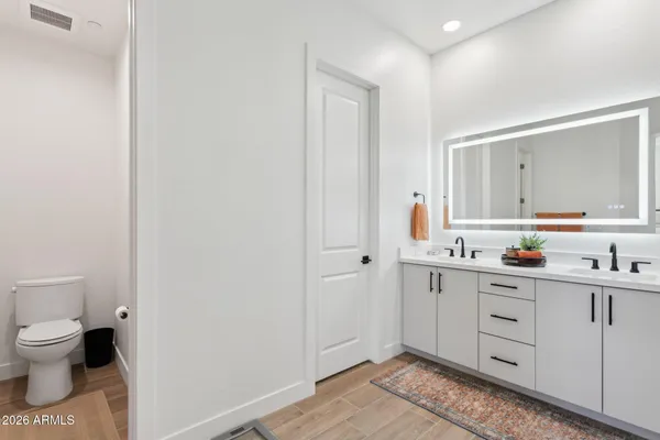 a spacious bathroom with double sink and a mirror