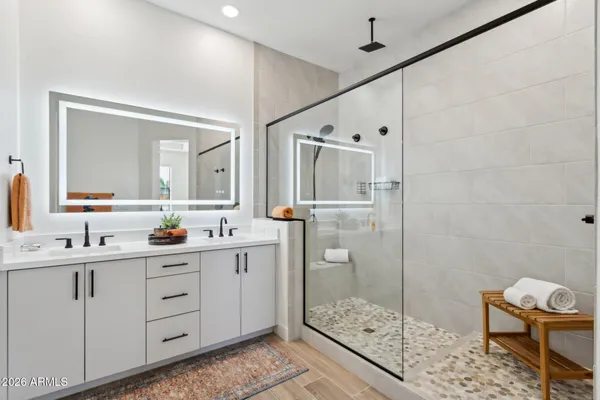 a bedroom with a bed and a flat screen tv in a room