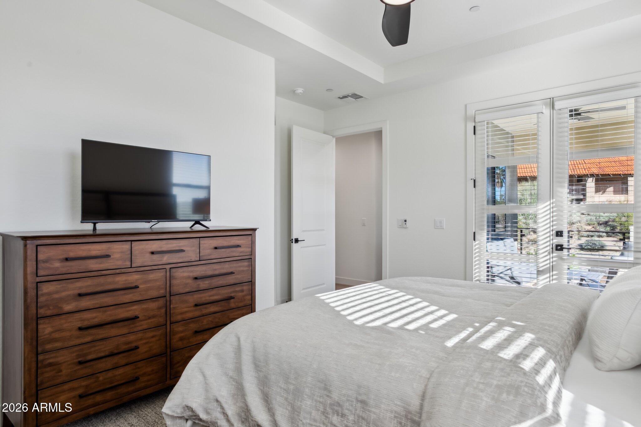 1 Easy Street, Unit 30 Carefree, AZ 85377 - Photo 29 of 70 a bedroom with a bed and a flat screen tv in a room