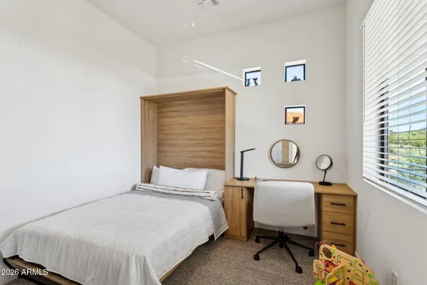 a bedroom with a bed and a window