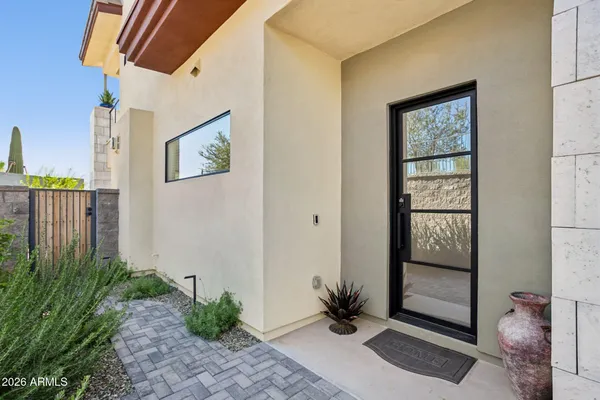 a view of a door and chair in the patio
