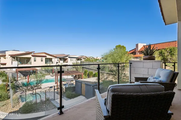 a balcony with a table and chairs
