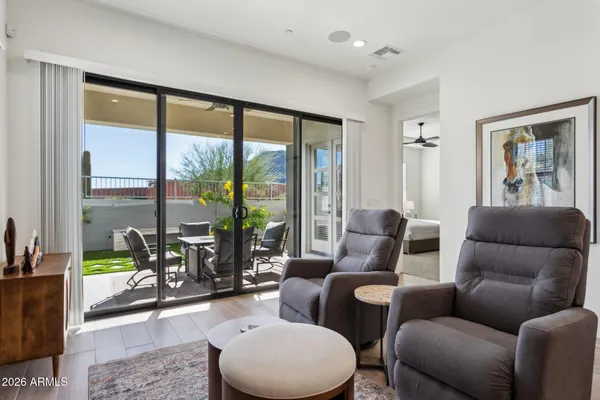 a living room with furniture and a floor to ceiling window