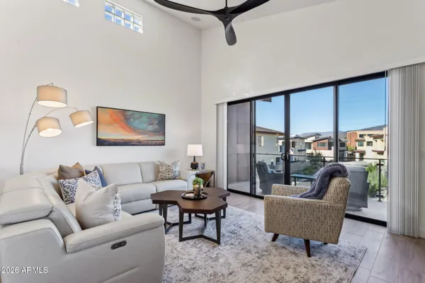 a living room with furniture and a potted plant