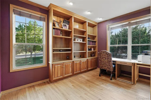 a view of a workspace with furniture and a window