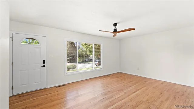 wooden floor in an empty room with a window