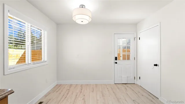 a view of a room with wooden floor and windows