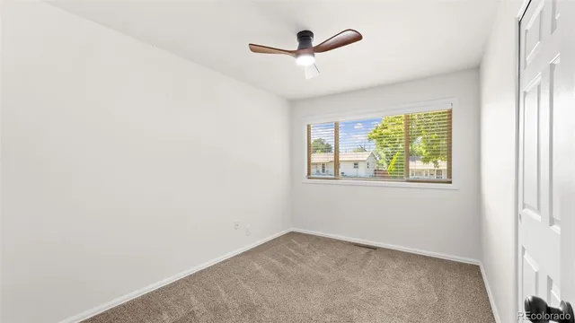 a bed room with a bed and a painting on the wall