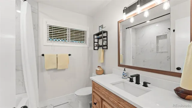 an empty room with a window and a ceiling fan