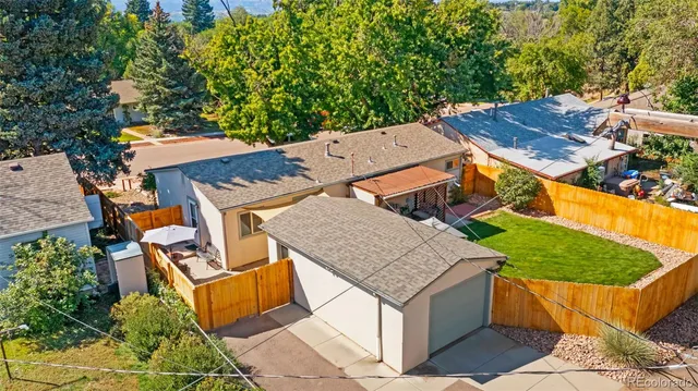 an aerial view of a house with swimming pool and glass windows