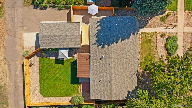 an aerial view of a house with a yard swimming pool and outdoor seating