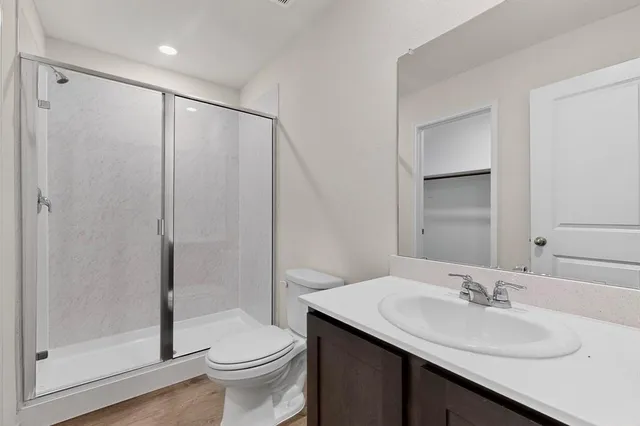 a bathroom with a sink toilet and shower