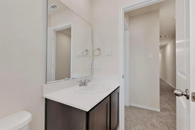a bathroom with a sink toilet and vanity