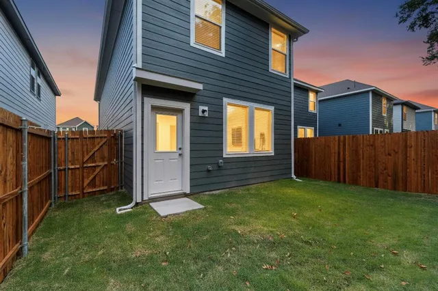 a view of backyard with wooden fence