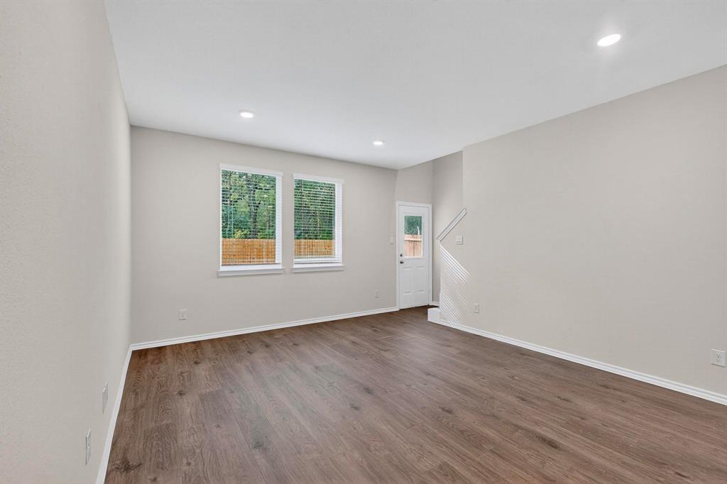 7008 Vining Drive Princeton, TX 75407 - Photo 5 of 34 an empty room with wooden floor and windows