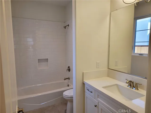 a view of a room with wooden floor and a window