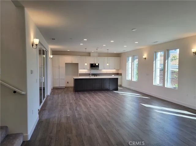 a view of kitchen with wooden floor and windows