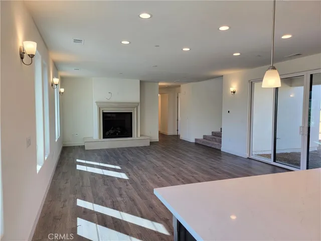 a view of a room with wooden floors and fireplace