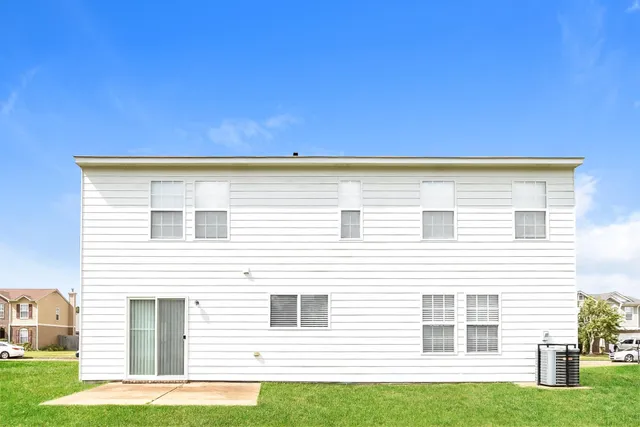a view of house with backyard