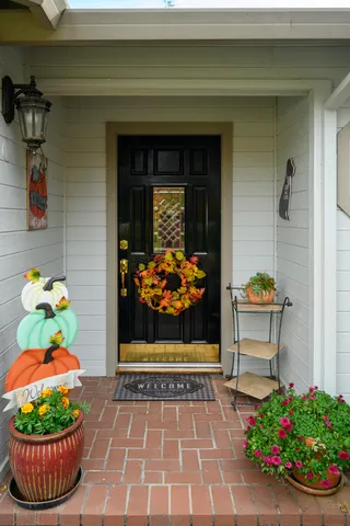 a front view of a house with a potted plant