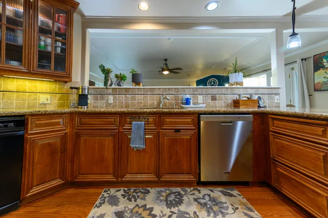 a kitchen with stainless steel appliances granite countertop a sink and cabinets