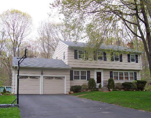205 Beacon Hill Road Trumbull, CT 06611 - Photo 1 of 1 a front view of a house with a yard and garage