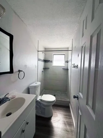 a bathroom with a sink toilet and shower