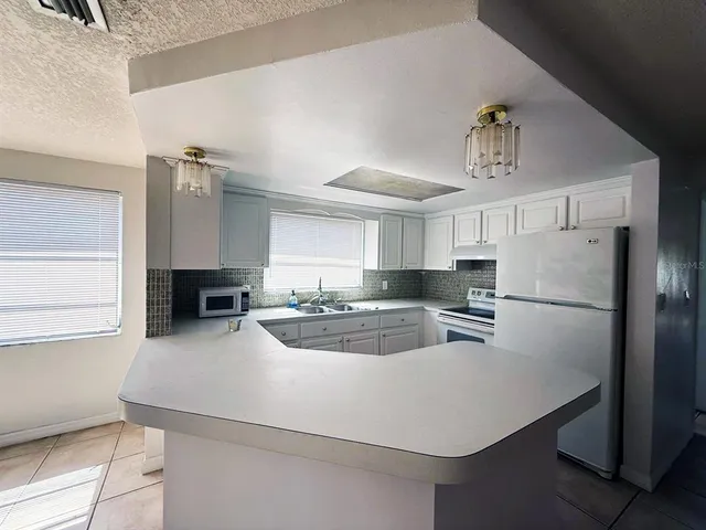 a kitchen with refrigerator cabinets and wooden floor