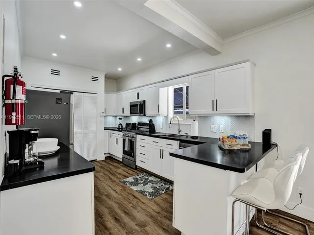 a kitchen with sink refrigerator and stove