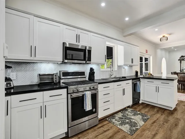 a kitchen with cabinets and appliances