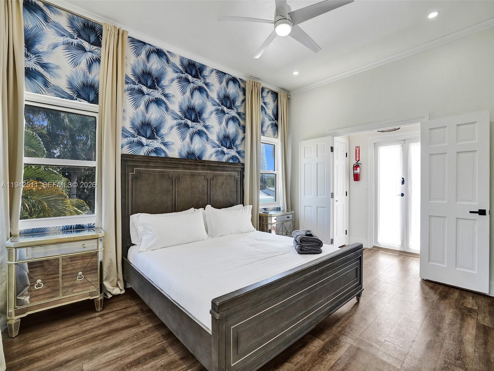 1128 Tyler Street Hollywood, FL 33019 - Photo 17 of 60 a bedroom with a large bed and a window