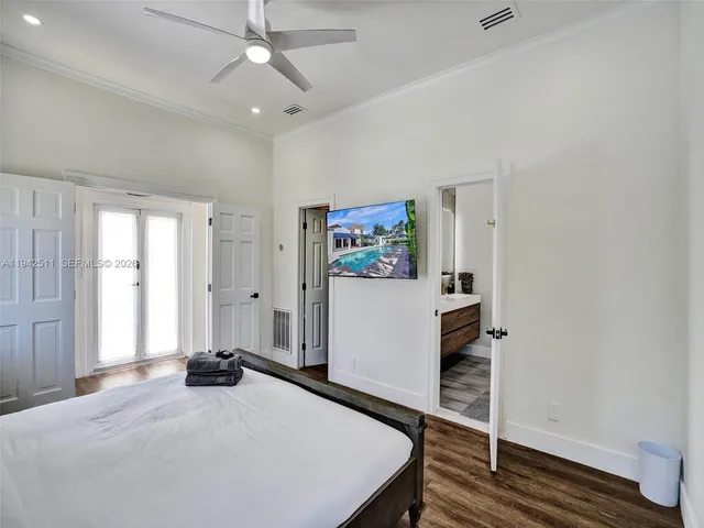 a bedroom with a bed and a painting on the wall