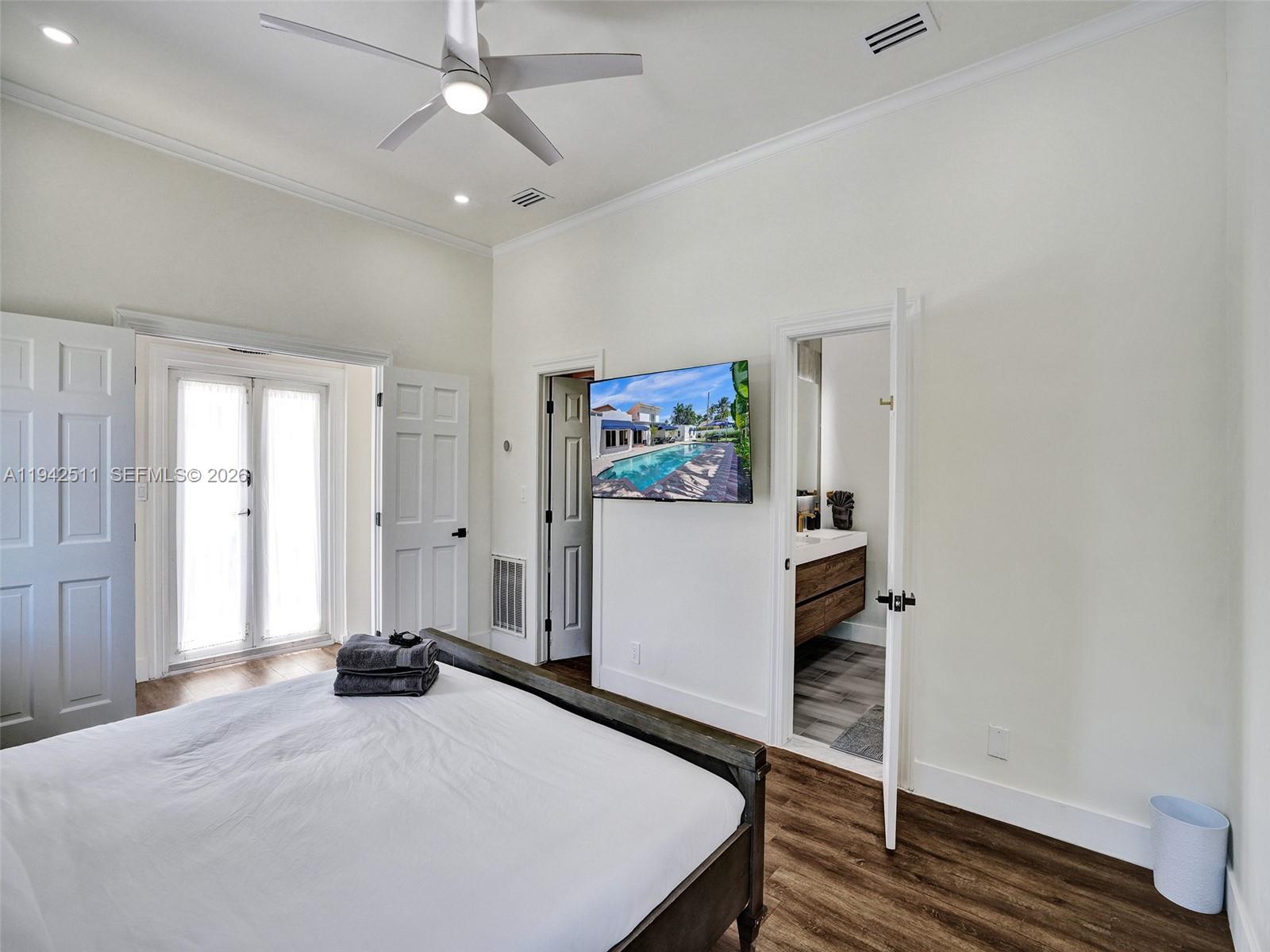 1128 Tyler Street Hollywood, FL 33019 - Photo 18 of 60 a bedroom with a bed and a window