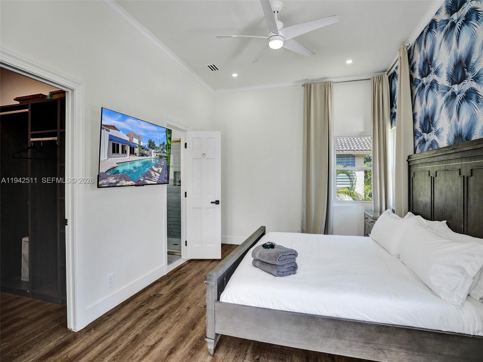 1128 Tyler Street Hollywood, FL 33019 - Photo 19 of 60 a bedroom with a bed and a painting on the wall