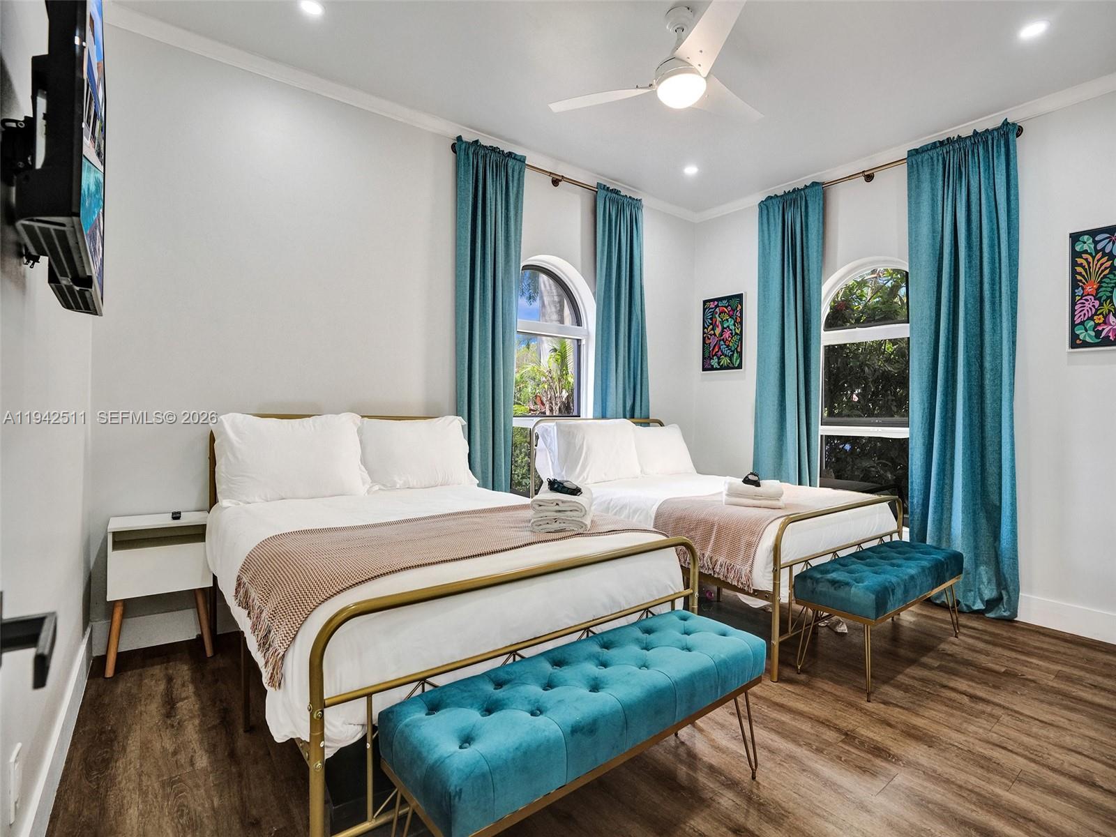 1128 Tyler Street Hollywood, FL 33019 - Photo 24 of 60 a spacious bedroom with a bed and a window