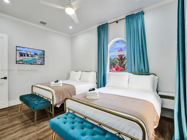 a bedroom with a bed and a painting on the wall