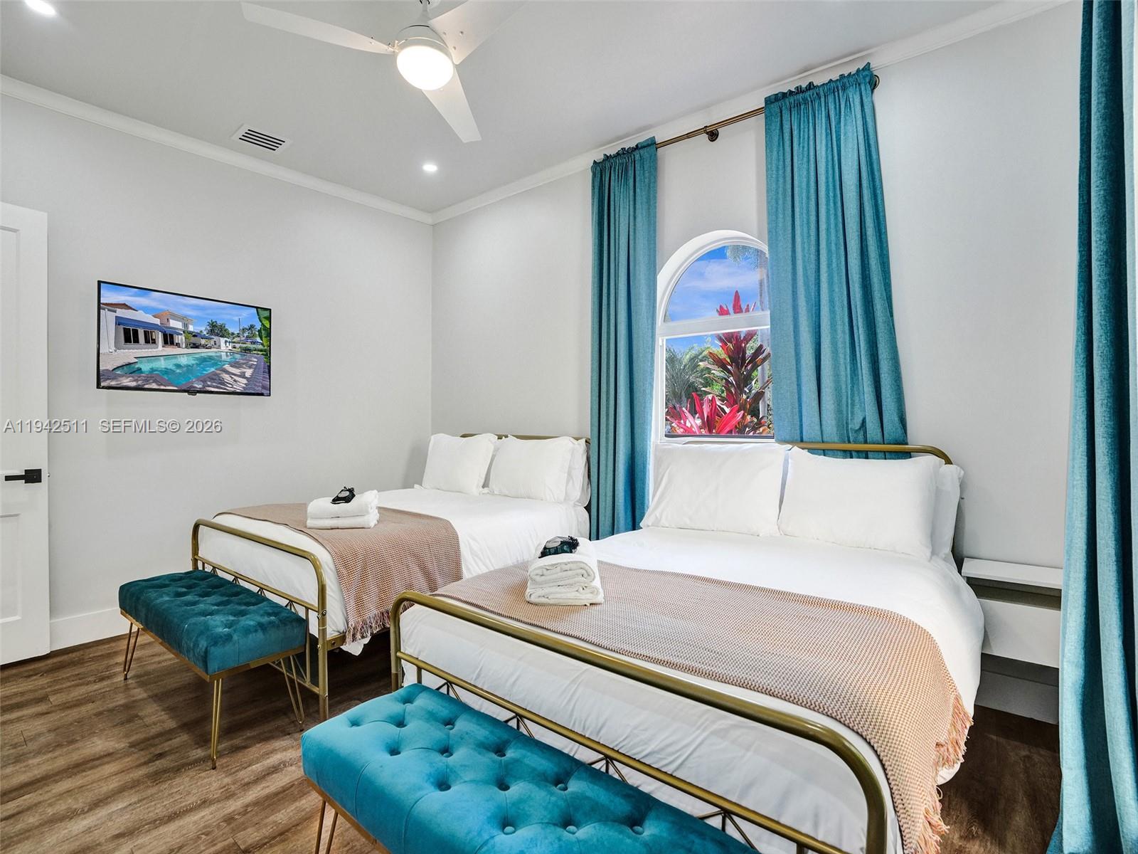 1128 Tyler Street Hollywood, FL 33019 - Photo 25 of 60 a bedroom with a bed and a painting on the wall