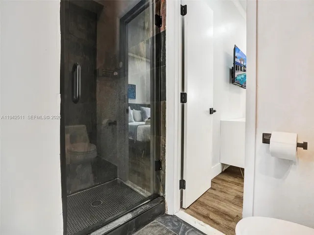 a bathroom with a bathtub a window and a shower