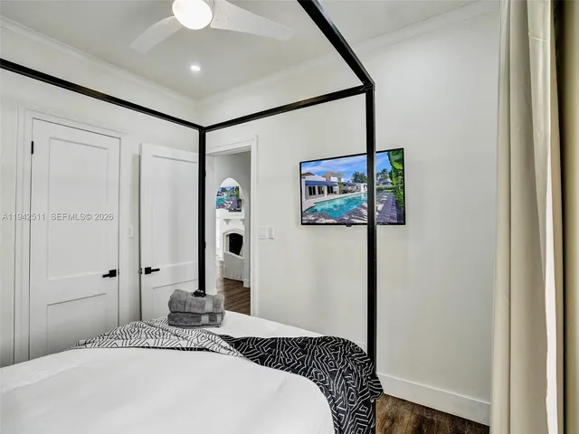 a bedroom with a bed and a chandelier