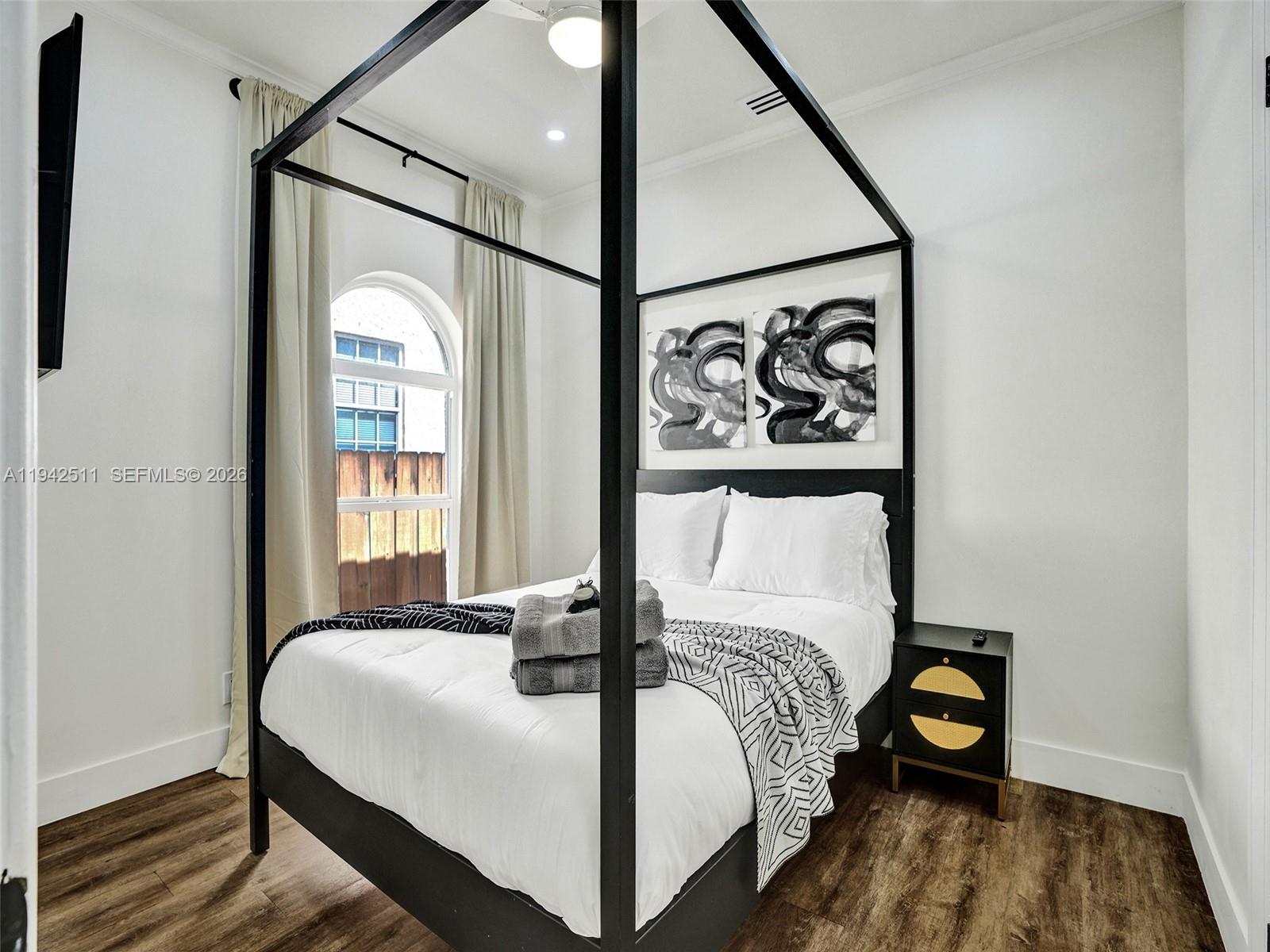 1128 Tyler Street Hollywood, FL 33019 - Photo 30 of 60 a bedroom with a bed and a painting on the wall