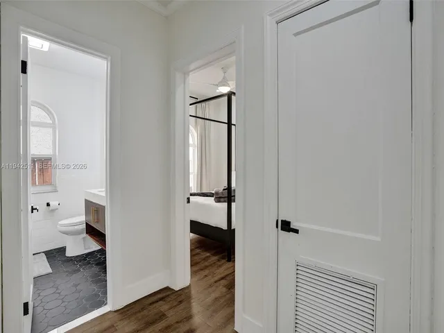 a bedroom with bed and painting on the wall