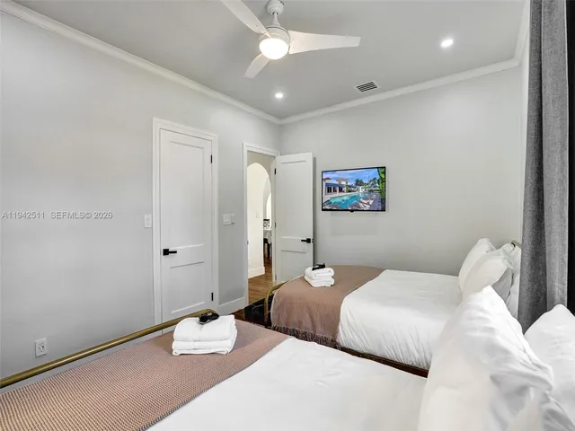 a living room with furniture and kitchen chandelier