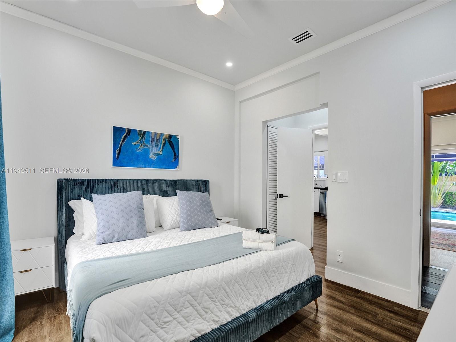 1128 Tyler Street Hollywood, FL 33019 - Photo 36 of 60 a bedroom with bed and painting on the wall