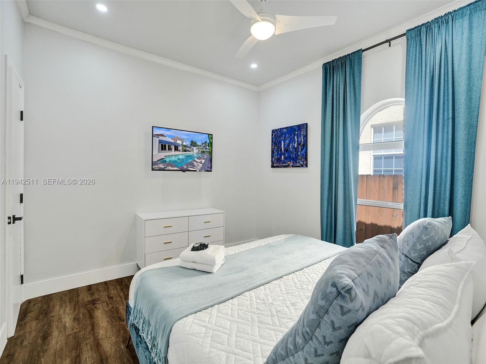 1128 Tyler Street Hollywood, FL 33019 - Photo 38 of 60 a bedroom with a bed and a painting on the wall