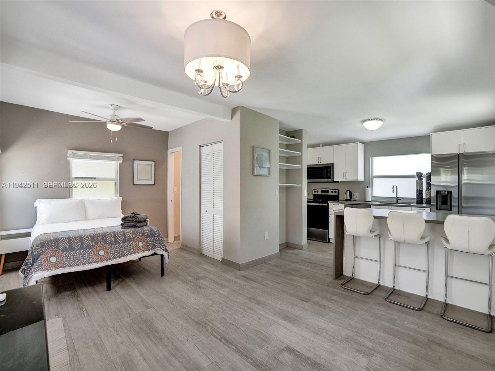 1128 Tyler Street Hollywood, FL 33019 - Photo 40 of 60 a living room with furniture and kitchen chandelier