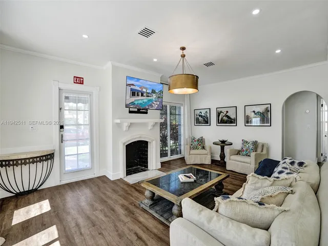 a living room with furniture fireplace and a large window