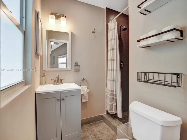 an aerial view of house with yard and outdoor seating