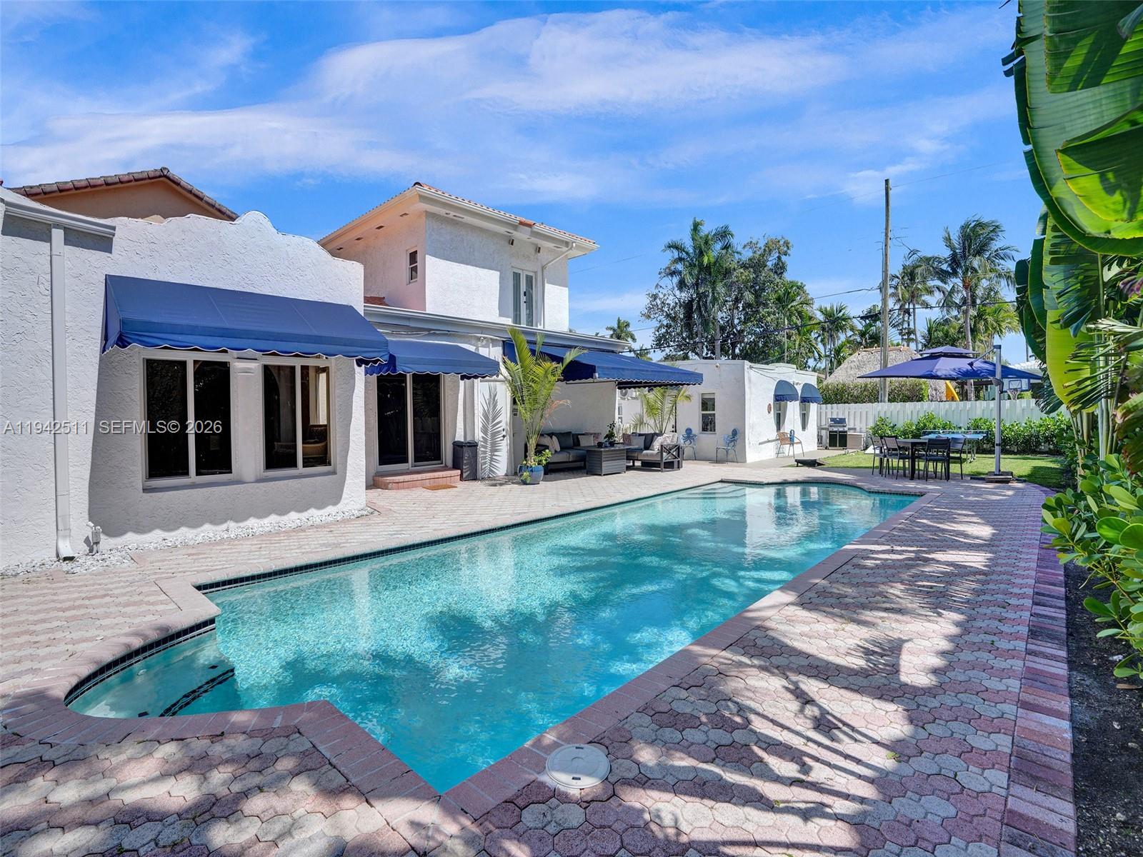 1128 Tyler Street Hollywood, FL 33019 - Photo 48 of 60 a view of a house with a yard