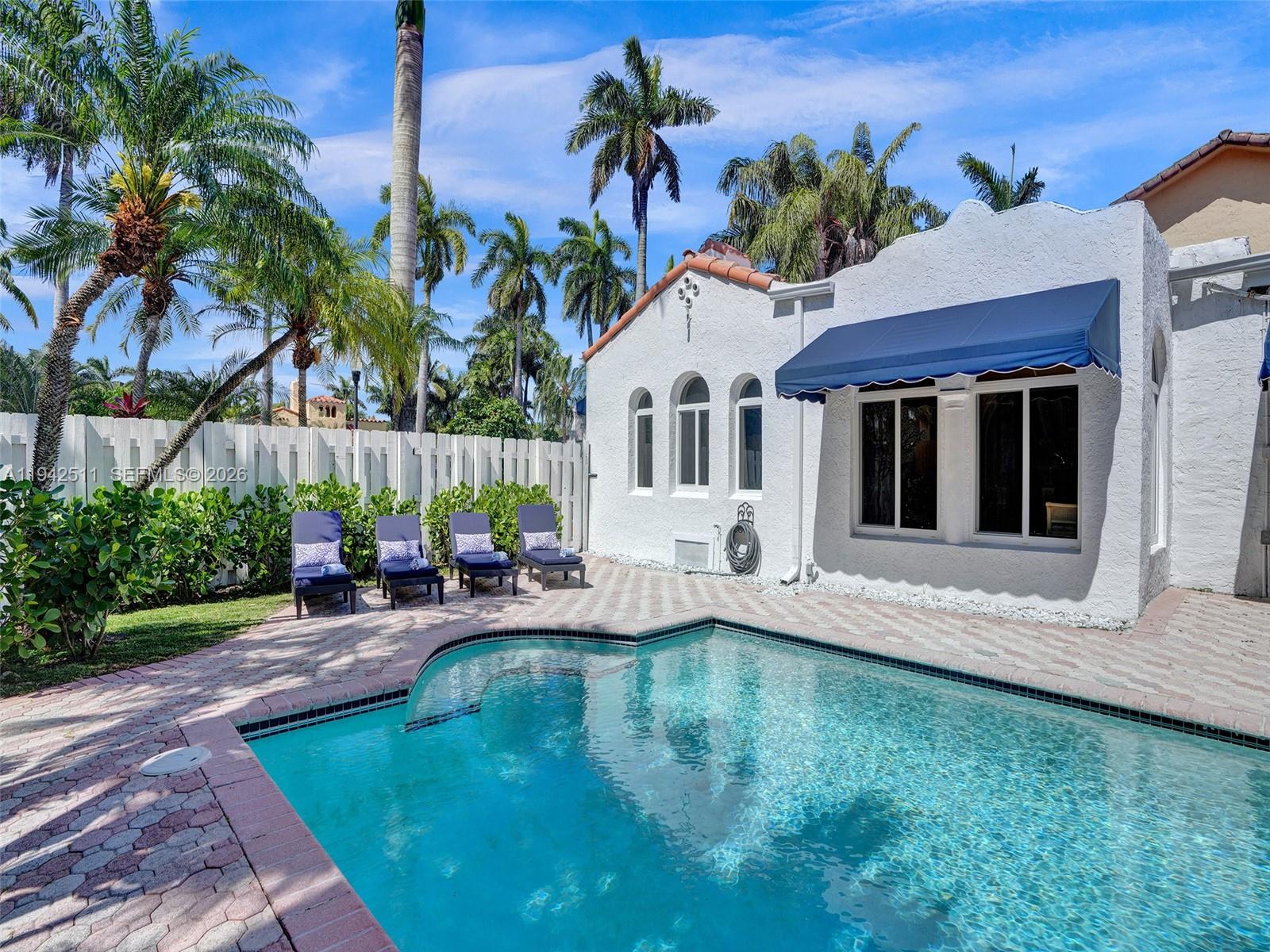 1128 Tyler Street Hollywood, FL 33019 - Photo 49 of 60 a view of a house with swimming pool and sitting area