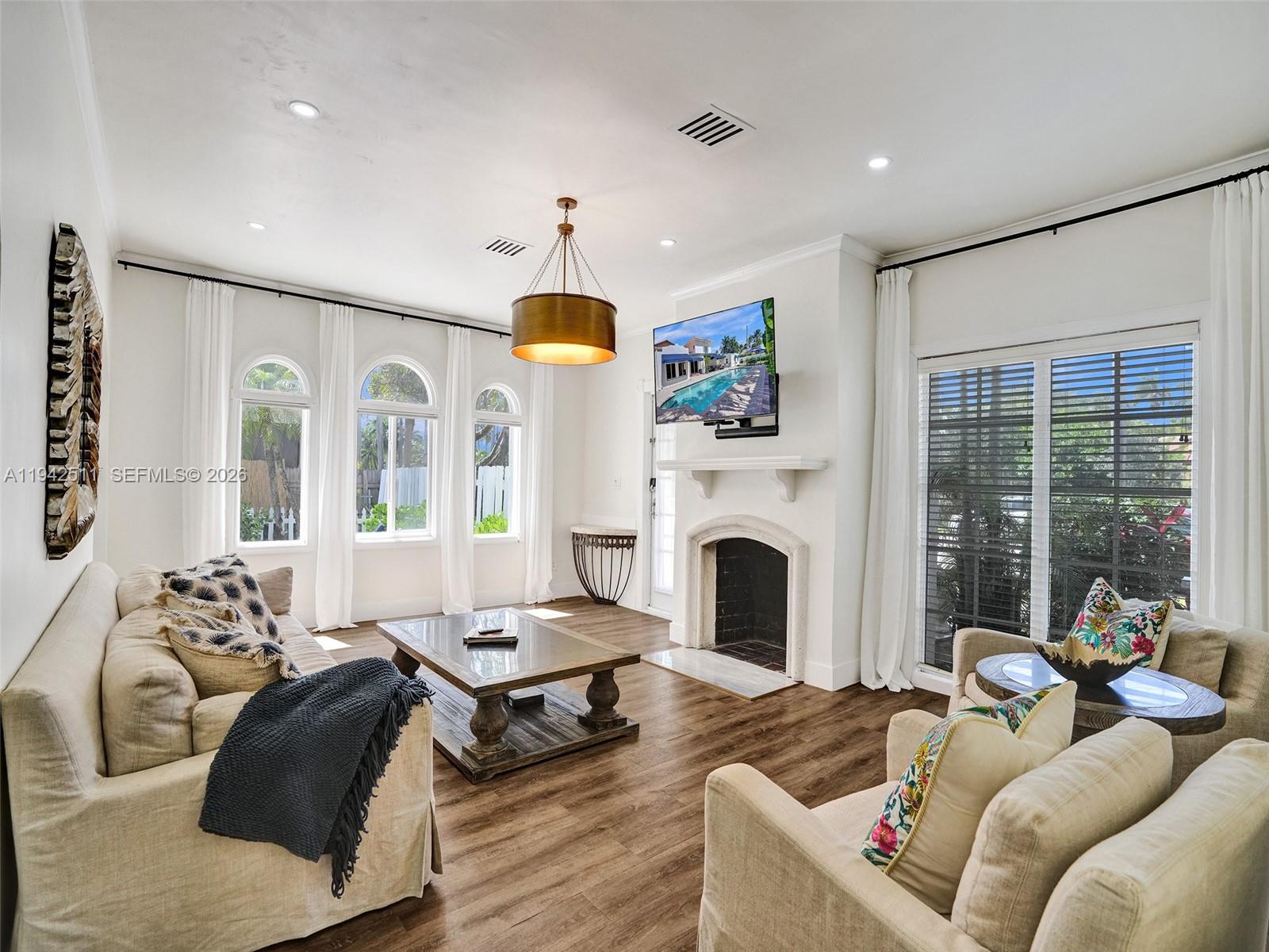 1128 Tyler Street Hollywood, FL 33019 - Photo 5 of 60 a living room with furniture fireplace and a large window